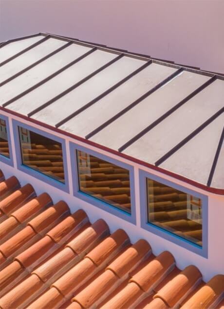 Metal roof accent on tile roofing system