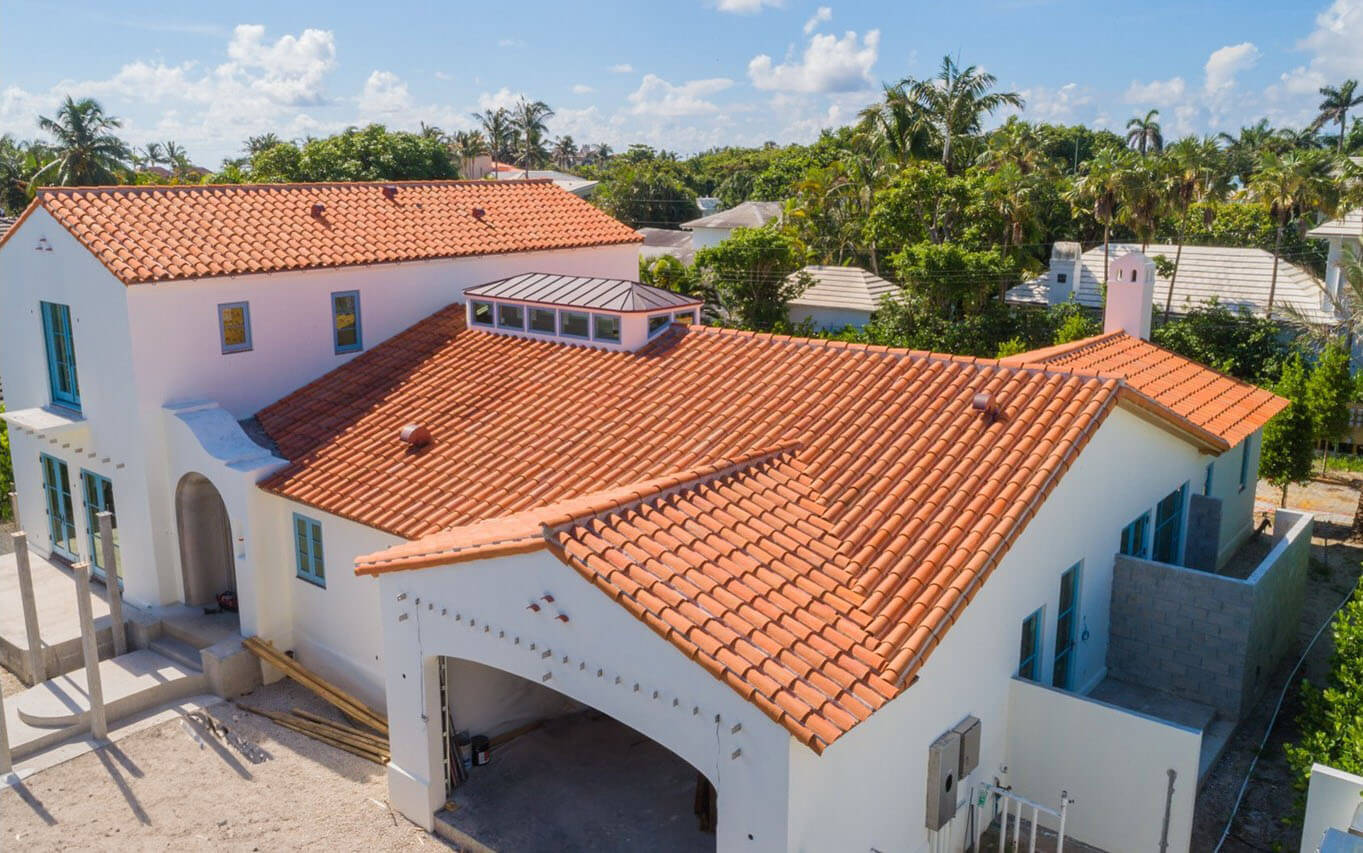 Large tile roofing on home in Florida with metal accents